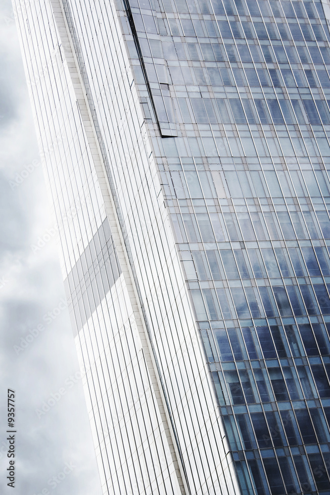 Naklejka premium Modern high glass business center wtih dramatci sky