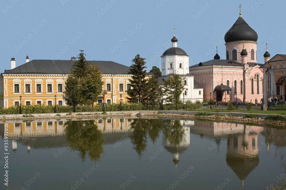 monastery is reflected in lake with water