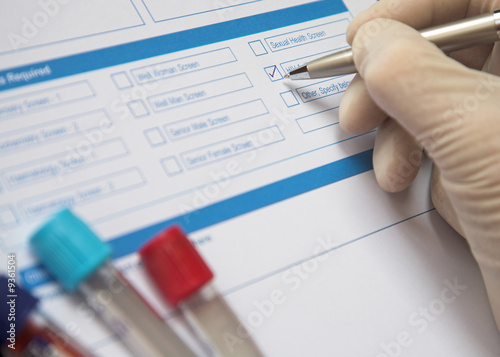 Doctor ticking box on a blood test form