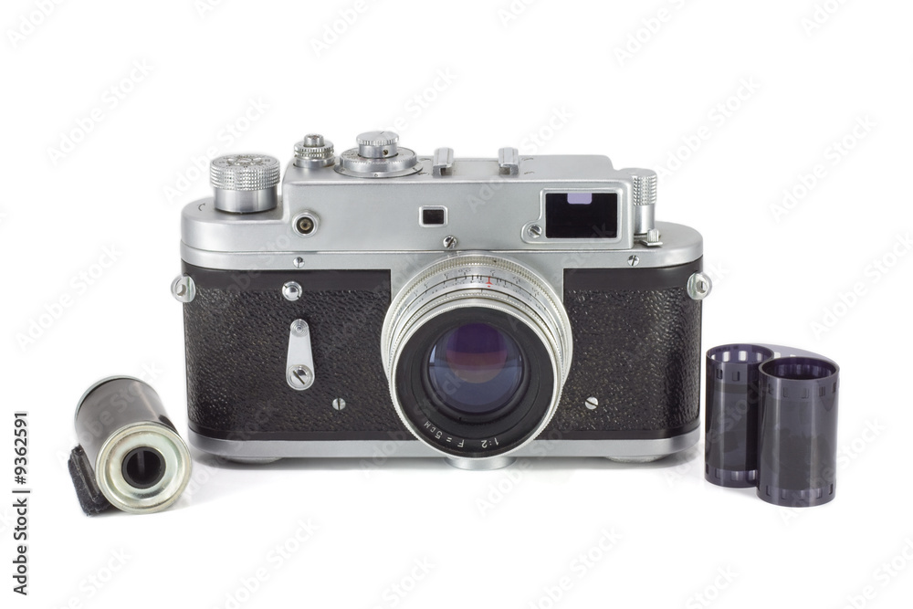 Old camera isolated on white with 35mm film roll