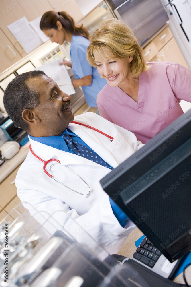 Obraz premium A Doctor And Nurse Discussing Something At The Reception Area Of