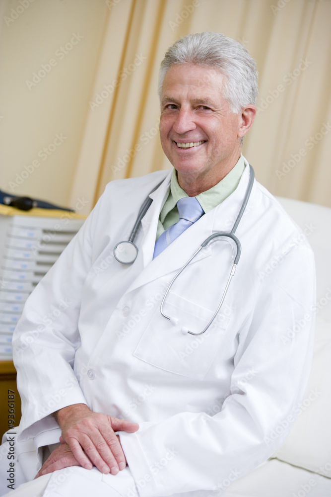 A Doctor Sitting On A Hospital Bed A Doctor Sitting On A Hospital Bed