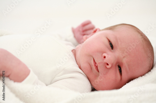 Lying baby on white background