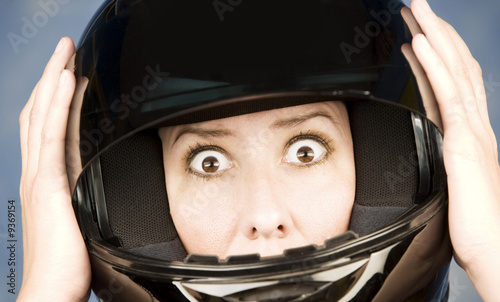 Woman with a black motrcycle helmet and surprised expression © Scott Griessel