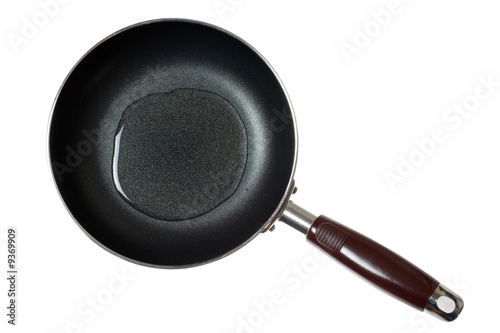Frying pan with cooking oil isolated on white background.