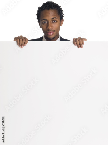 businessman holds a large blank sign ready for your message.