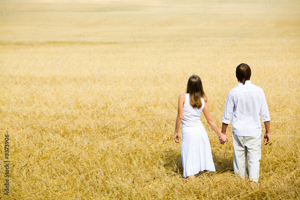 Image of couple walking along the field