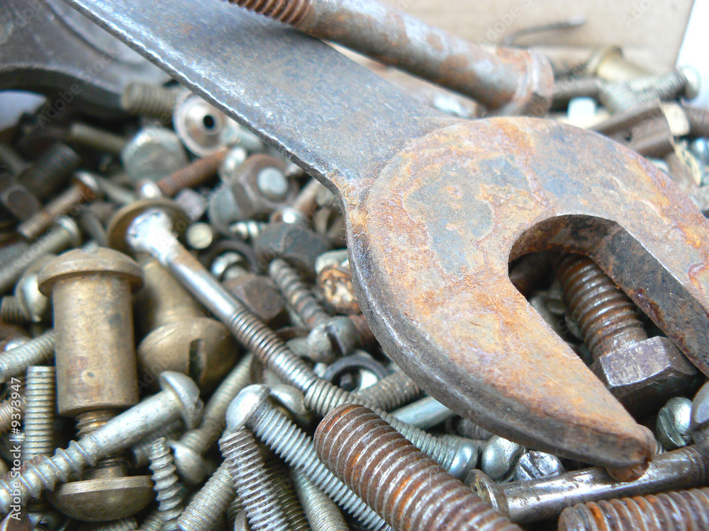 Assortment of rusty metal fasteners and wrench Assortment of rusty metal fasteners and wrench