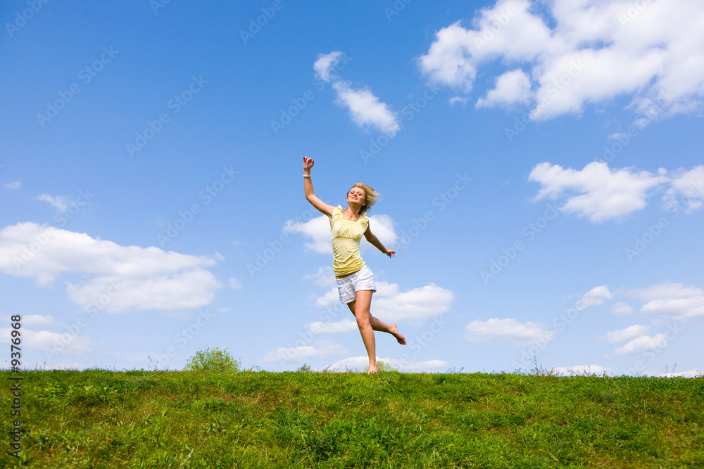Happy young woman is running in a field Happy young woman is running in a field