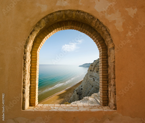 arched window on the coastal landscape of a bay #9379182