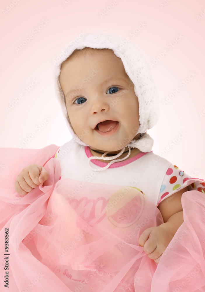 Portrait of the little girl in a knitted hat