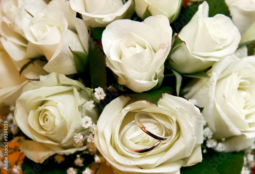 two wedding rings in rose bouquet