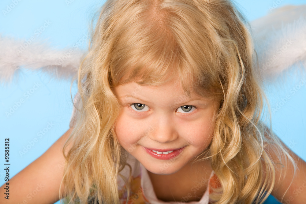 small girl dreessed as angel on blue background small girl dreessed as angel on blue background
