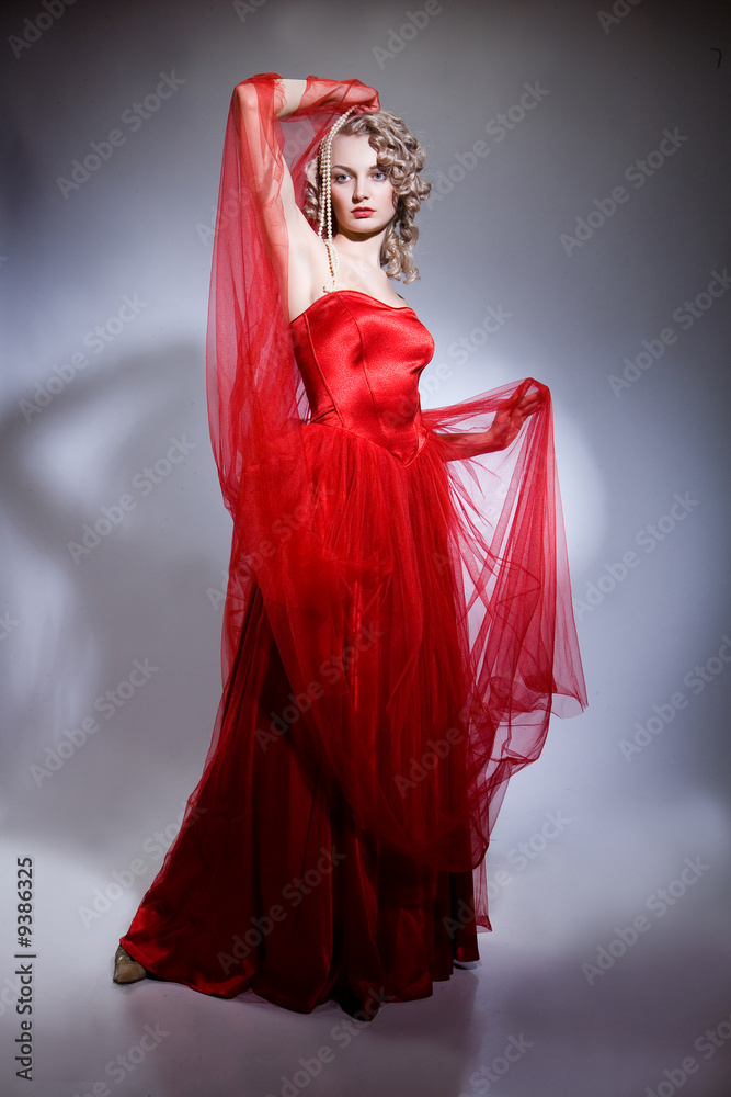 Young blonde woman in a red dress
