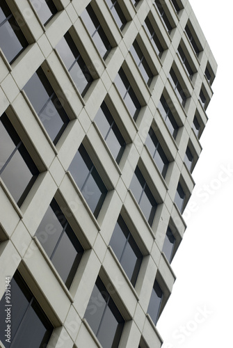 View upward of a tall cream building with many glass windows