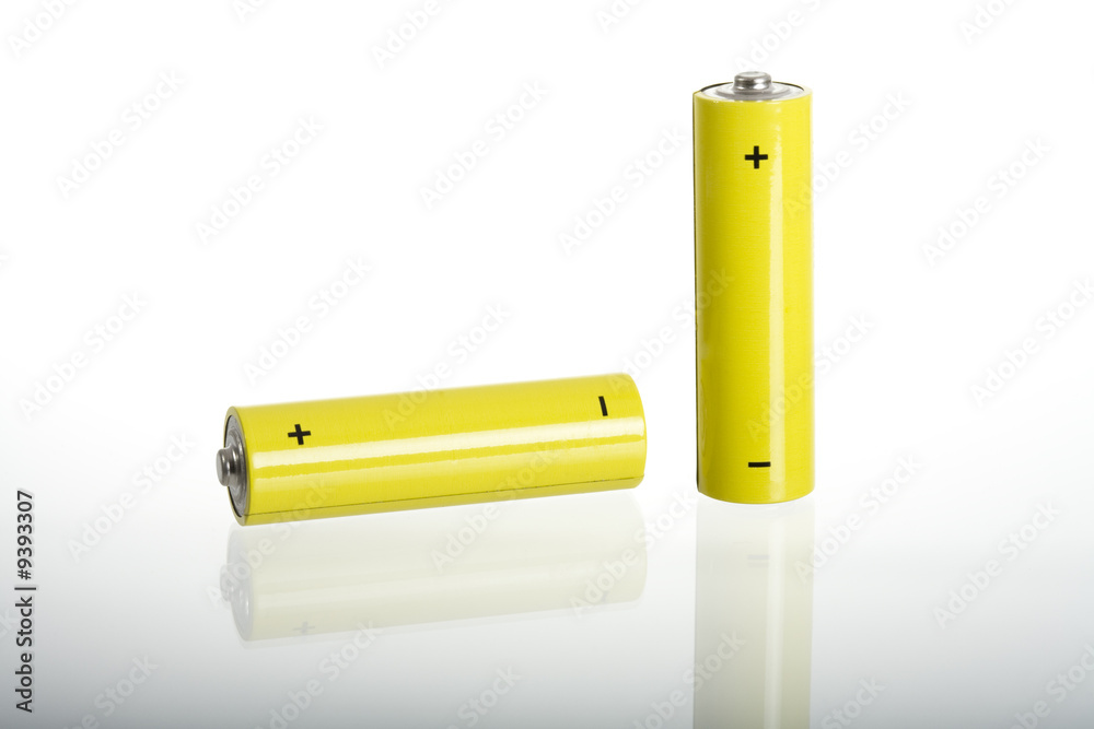 Two yellow batteries, isolated on white, reflection on glass Two yellow batteries, isolated on white, reflection on glass
