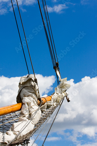 Tallship masts over cloudy blue sky