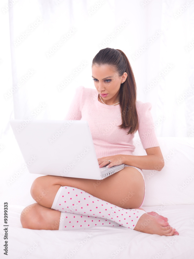 Young pretty women on couch relaxing and using laptop Young pretty women on couch relaxing and using laptop