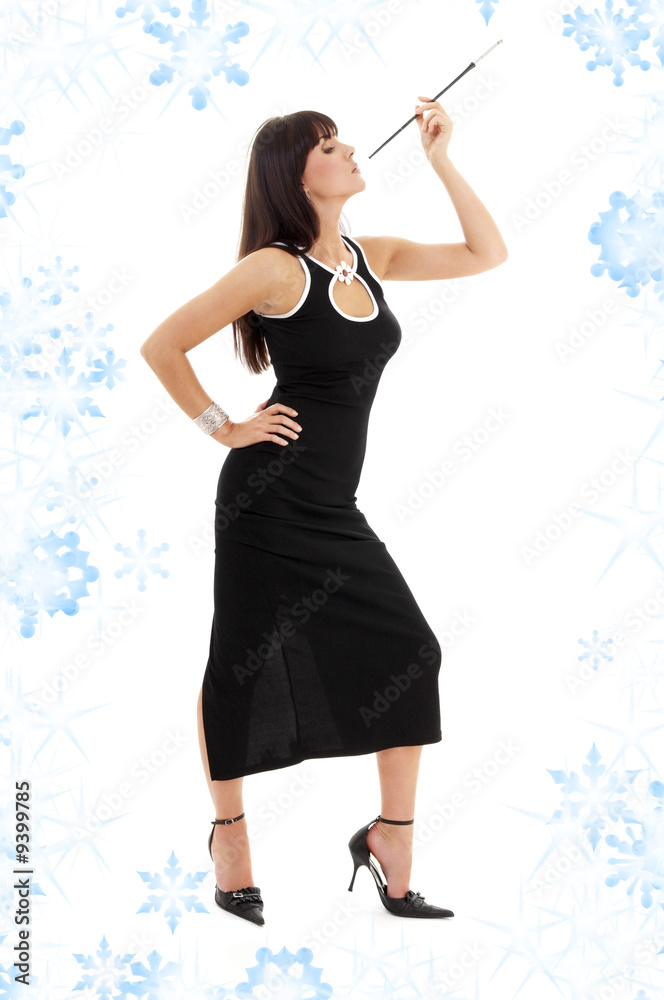 brunette in black dress with cigarette holder and snowflakes brunette in black dress with cigarette holder and snowflakes