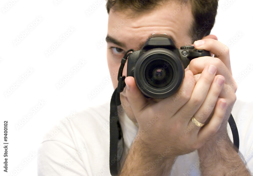 A young photographer taking a shot with his DSLR camera A young photographer taking a shot with his DSLR camera