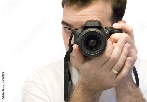 A young photographer taking a shot with his DSLR camera