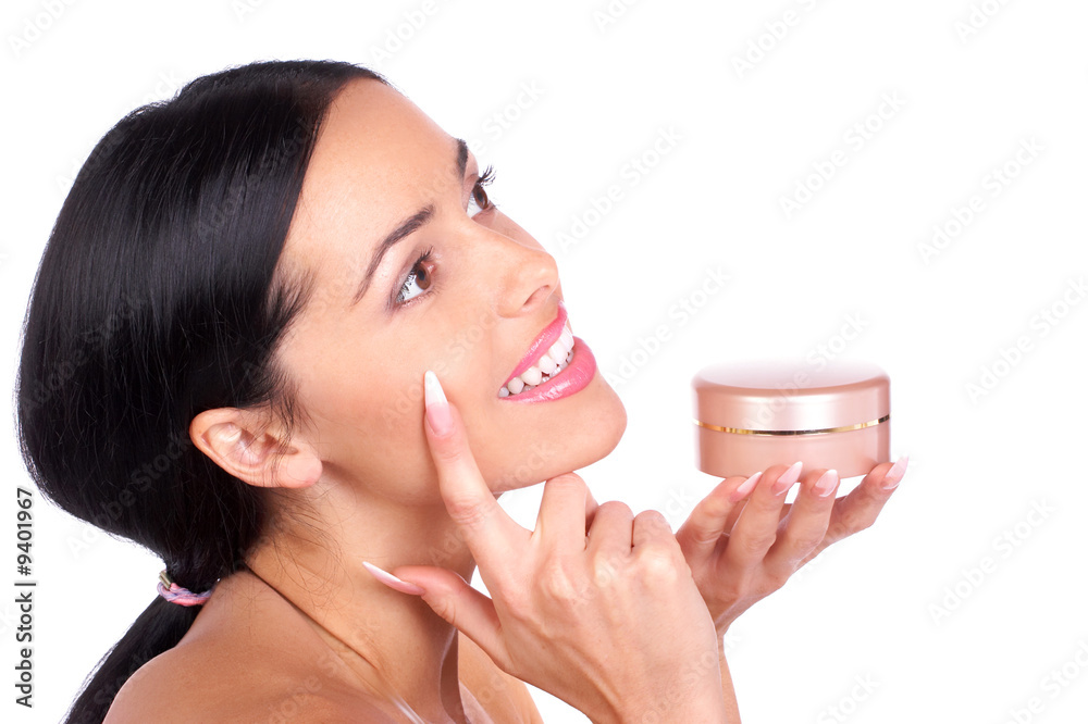 Beautiful young woman with cream . Over white background. Beautiful young woman with cream . Over white background.