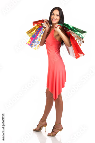Shopping  woman smiling. Isolated over white background.