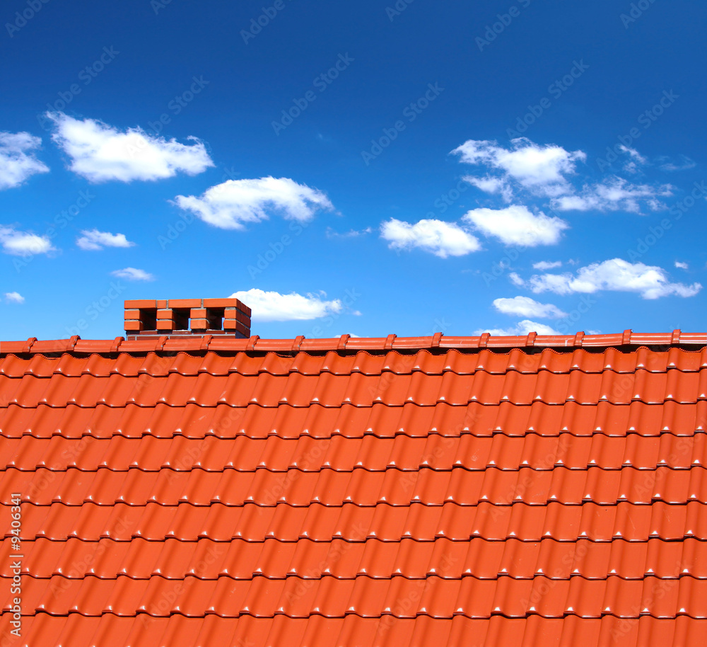red roofing-tiles with cumulus clouds above red roofing-tiles with cumulus clouds above