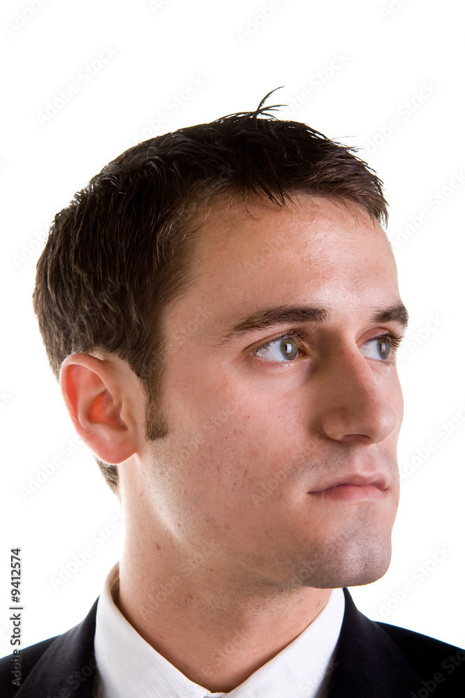 A young businessman with a serious expression looking left A young businessman with a serious expression looking left