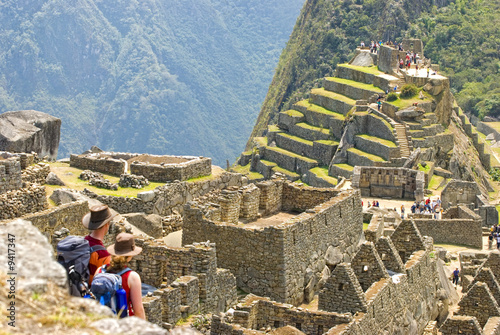Couple admiring Inca sanctuary of Machupicchu. Cusco, Peru