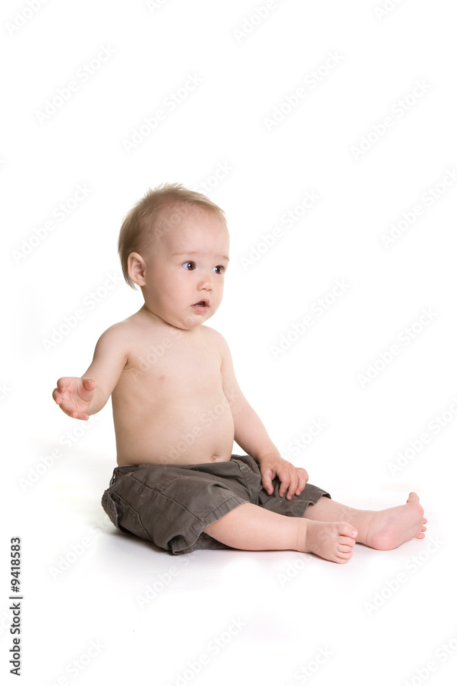 Surprised small baby sitting and raised his hand Surprised small baby sitting and raised his hand