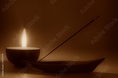 Still life with candle and incense stick, sepia toned #9420349