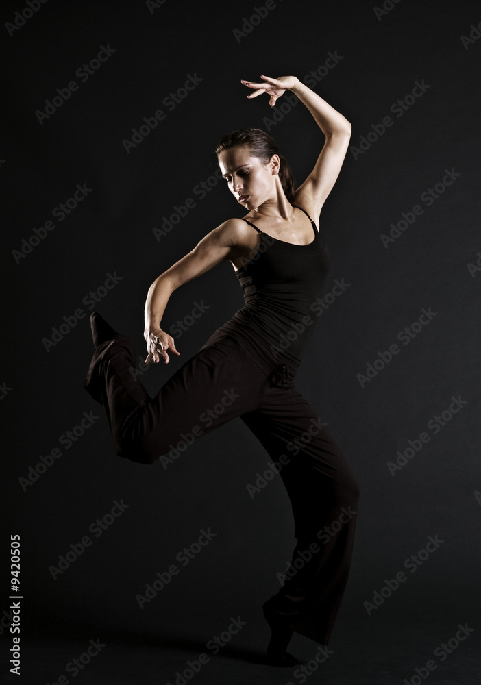 beautiful woman dancing over dark background