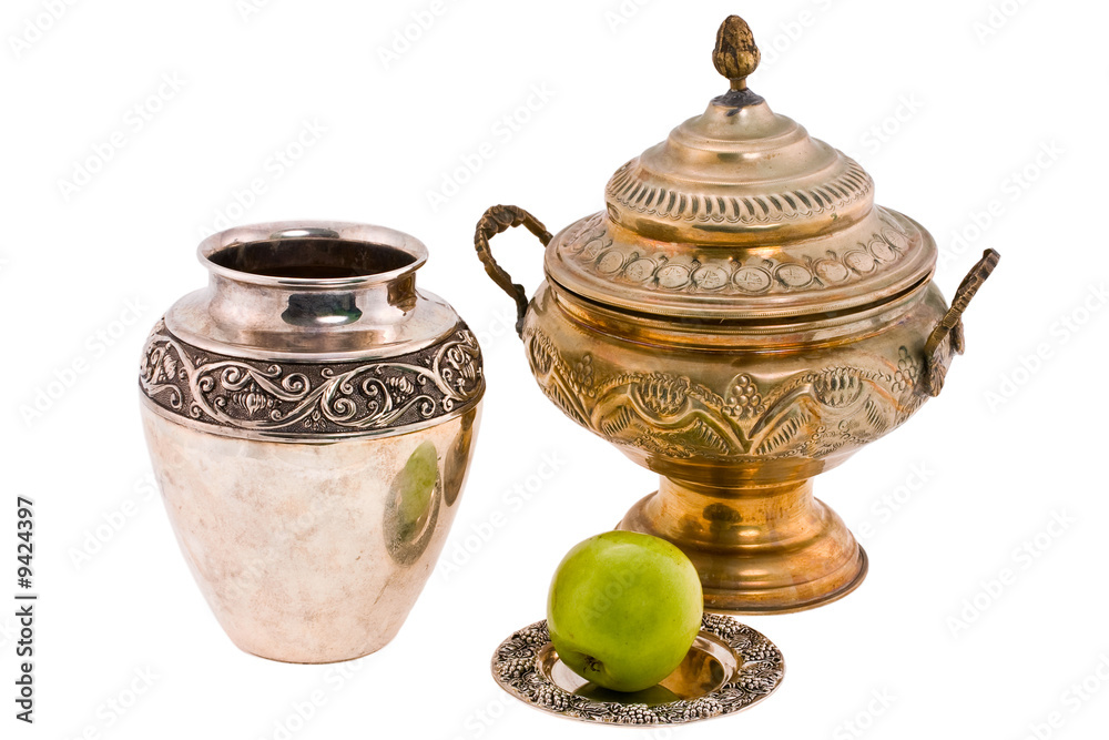 antique dishes and apple on white background