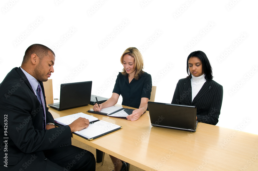 Two women and a man sit at conference table Two women and a man sit at conference table