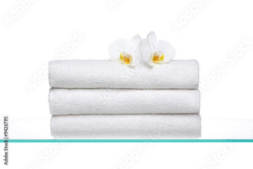 Fresh Towels with white Orchids on glass