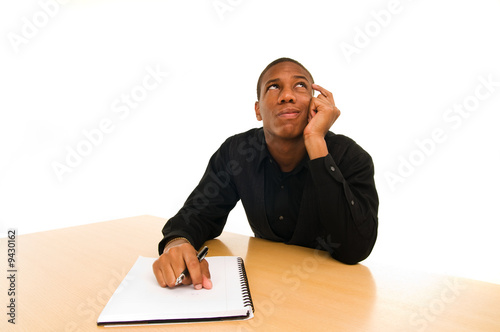 man sits at table with confused look on face