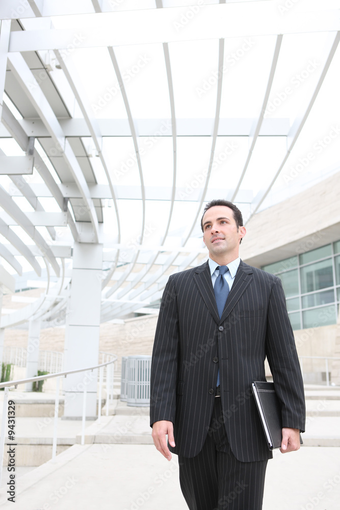 A young, handsome business man at the office building A young, handsome business man at the office building