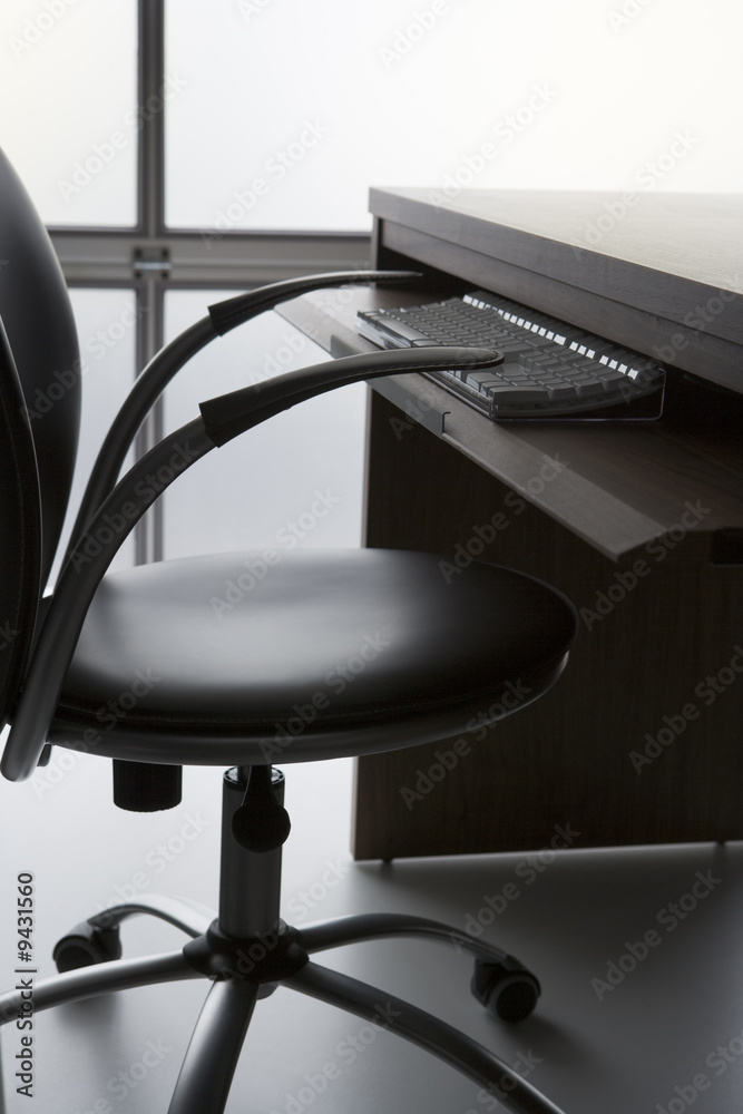 Empty Office Chair And Desk With Computer Keyboard Empty Office Chair And Desk With Computer Keyboard