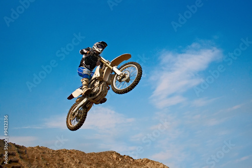 man on motorcycle on background blue sky