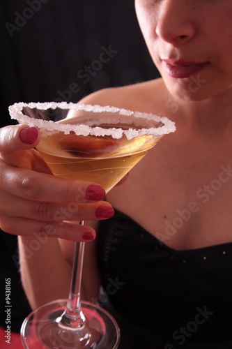 Beautiful young woman holding a martini glass