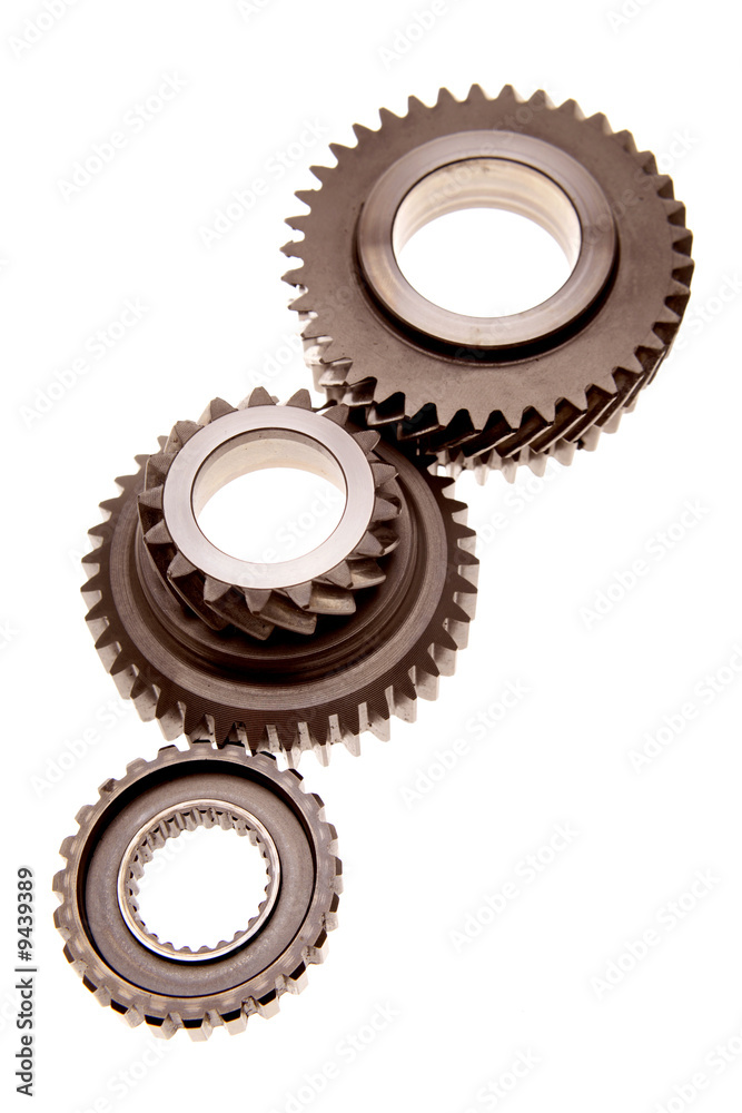 Three gears meshing together over white Three gears meshing together over white