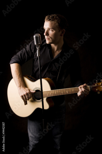 young musician playing a guitar and singing