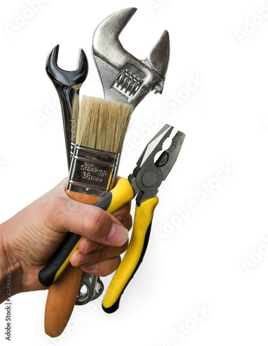 Hand holding a selection of tools - isolated on white