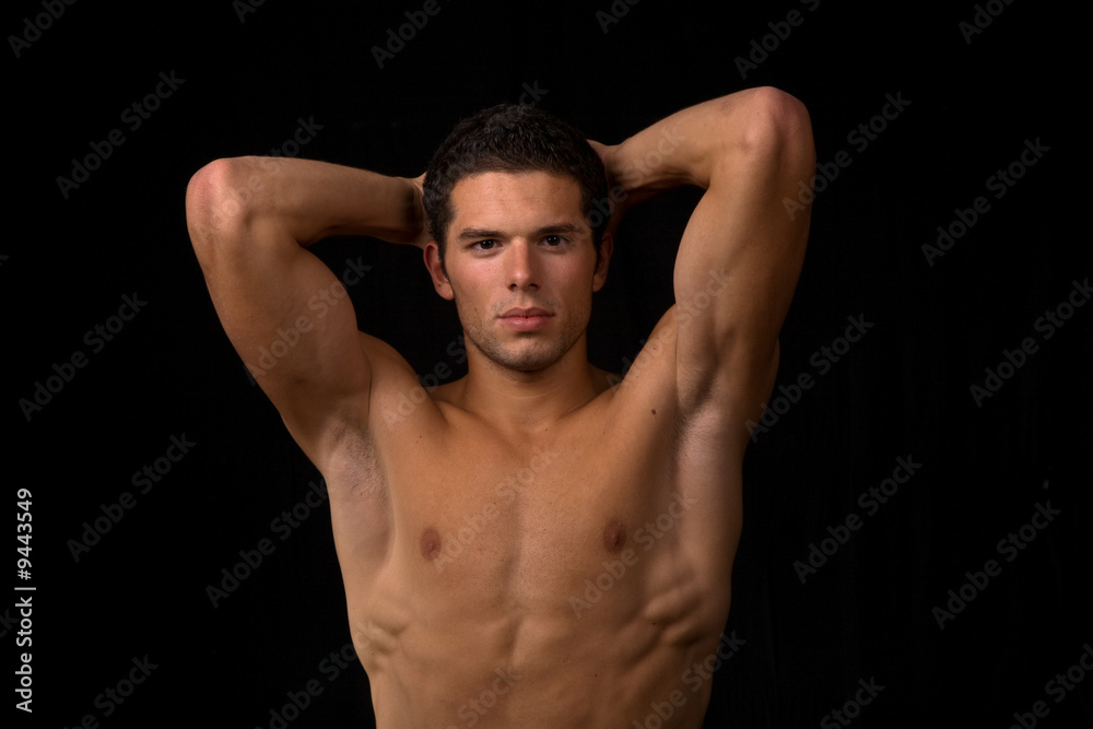 young sensual man on a black backgroung