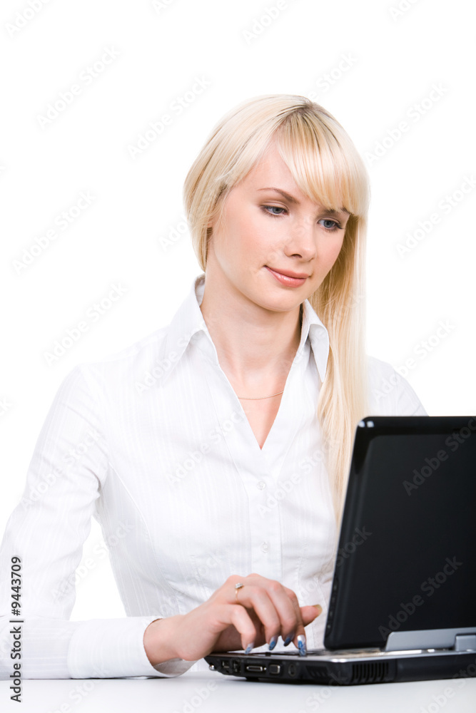 Portrait of blond woman sitting by laptop and working Portrait of blond woman sitting by laptop and working