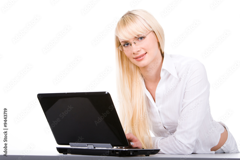 Photo of beautiful blonde looking at camera with laptop in front Photo of beautiful blonde looking at camera with laptop in front