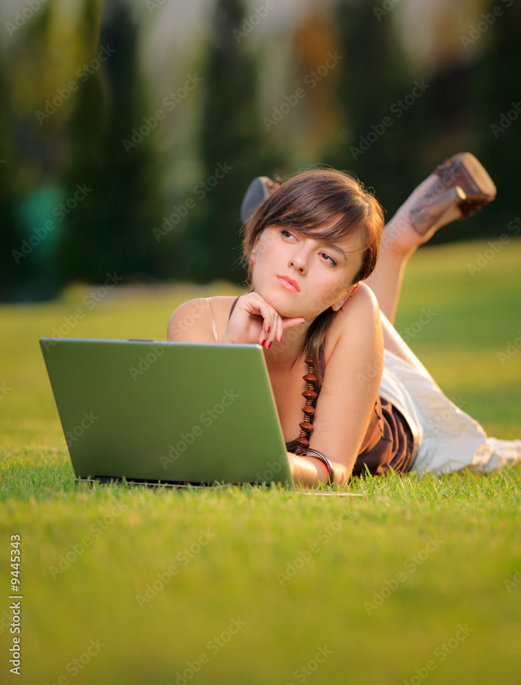 Female working on a laptop computer in the park