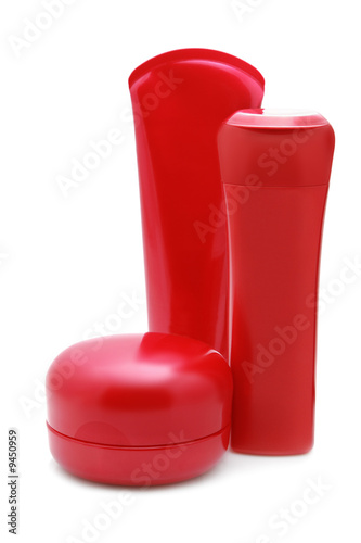 Set of red cosmetic bottles isolated over white background