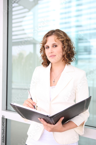 A young pretty business woman at office building Free Download A young pretty business woman at office building - GFXLoad